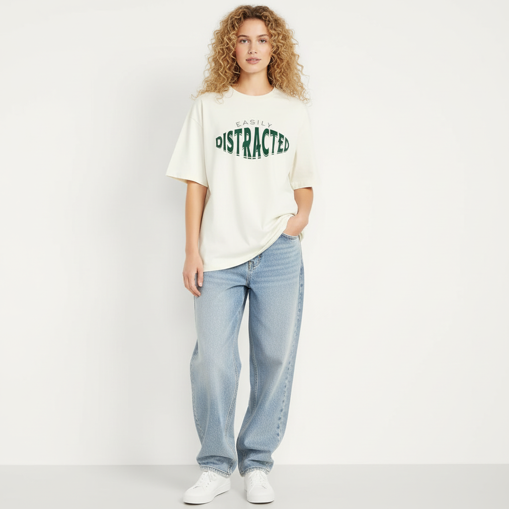 Woman wearing a white t-shirt with text and light blue jeans on a plain background