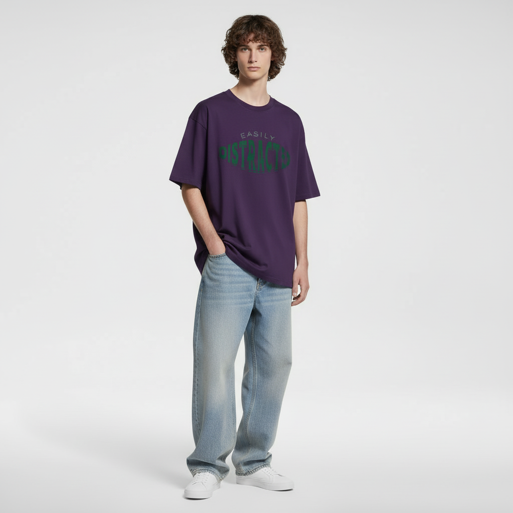 Person wearing a purple t-shirt with text and light blue jeans on a white background