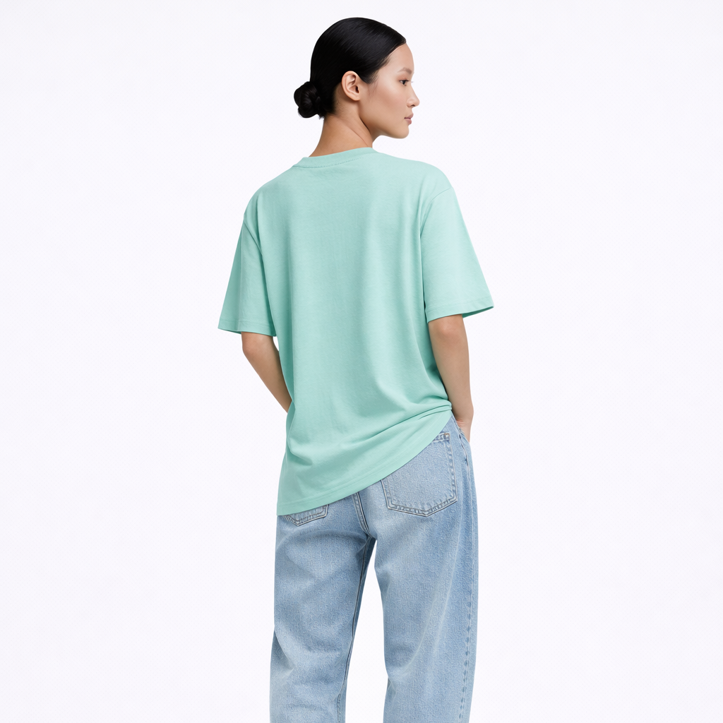 Person wearing a light green t-shirt and blue jeans on a white background